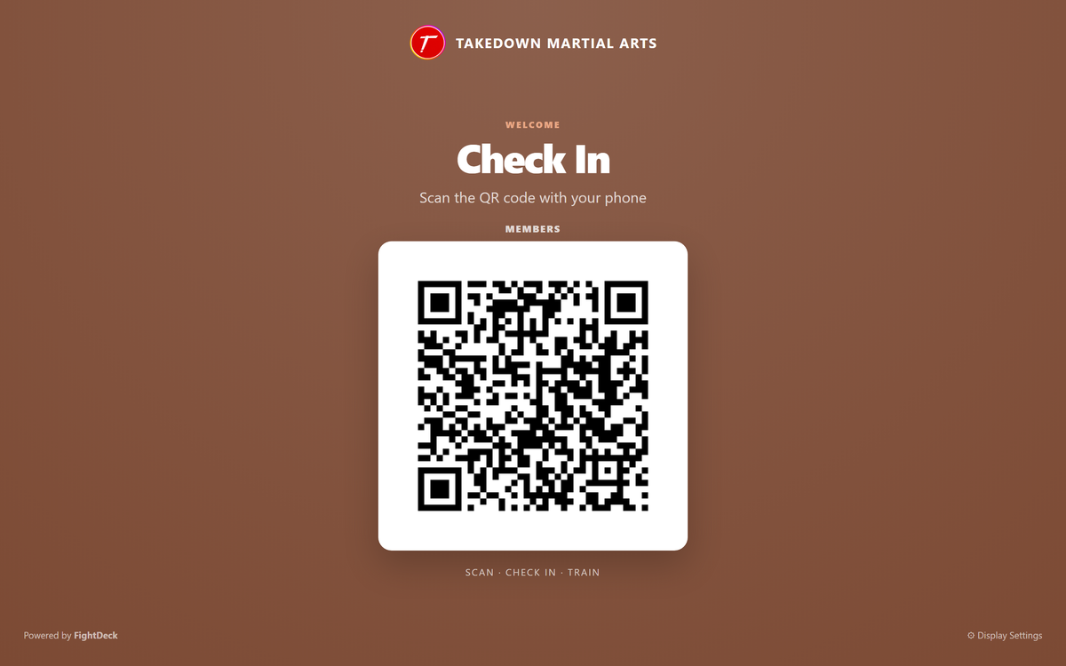 FightDeck check-in kiosk display with a QR code for members to scan
